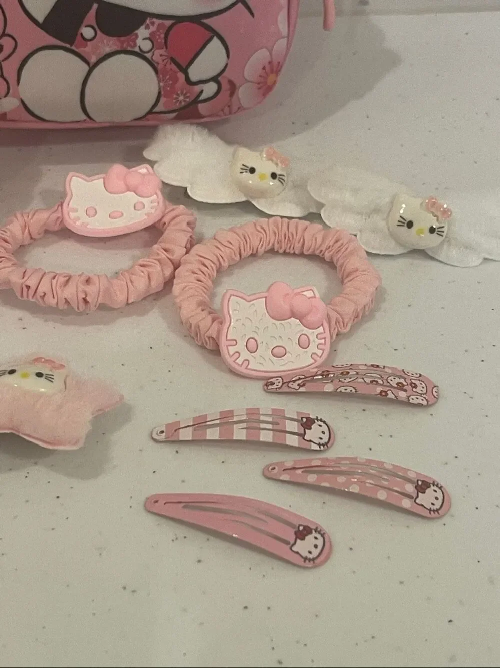 Hello Kitty mini back pack with 15 barrettes, hair clips and hair ties sticking